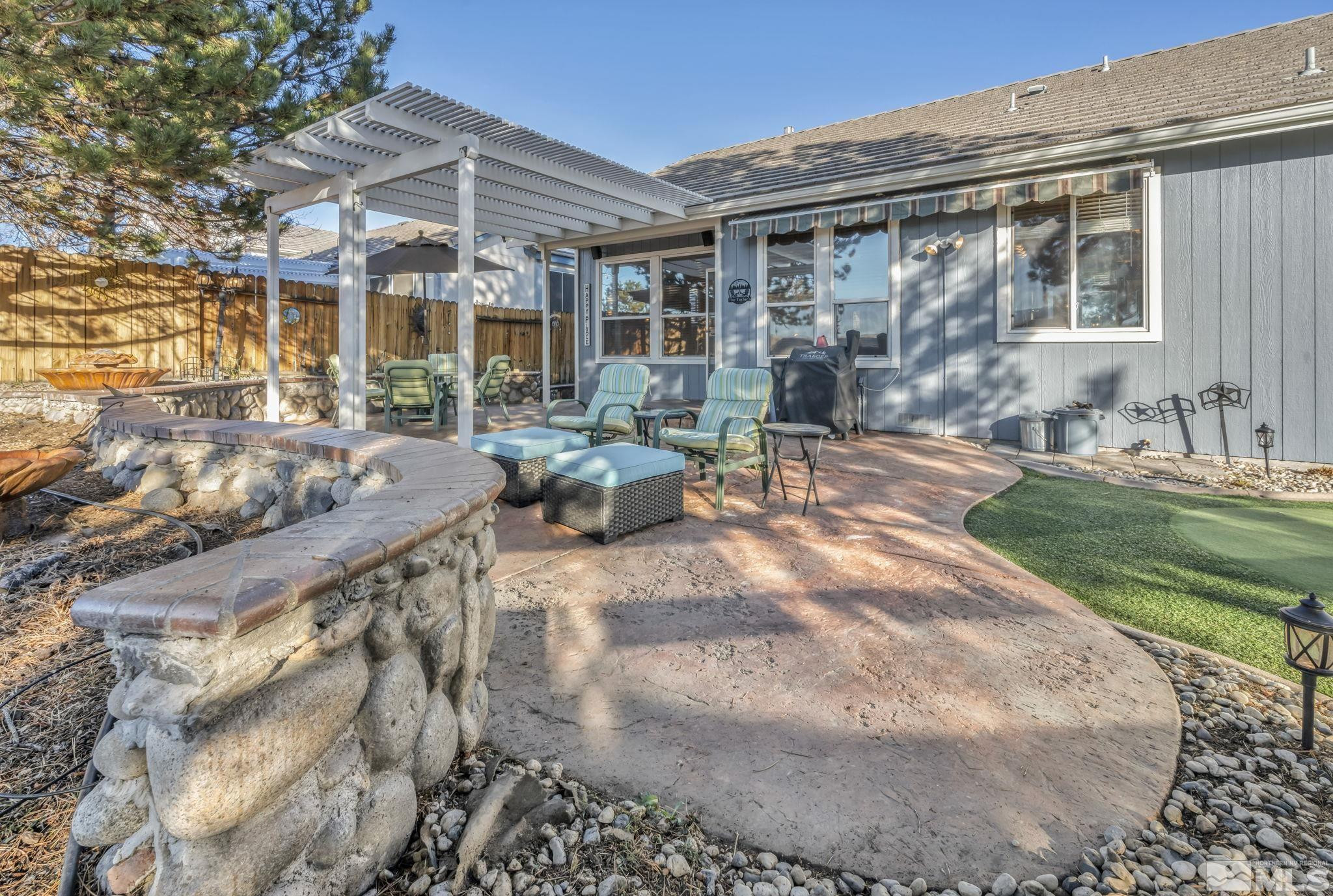 4805 Crestside Drive Sparks, NV 89436 - Photo 26 of 33 a view of a house with backyard sitting area and garden