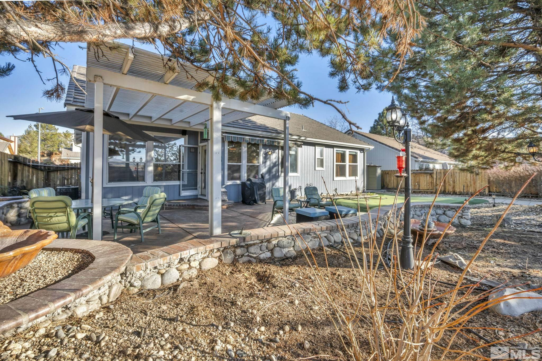 4805 Crestside Drive Sparks, NV 89436 - Photo 29 of 33 a view of a house with backyard porch and sitting area