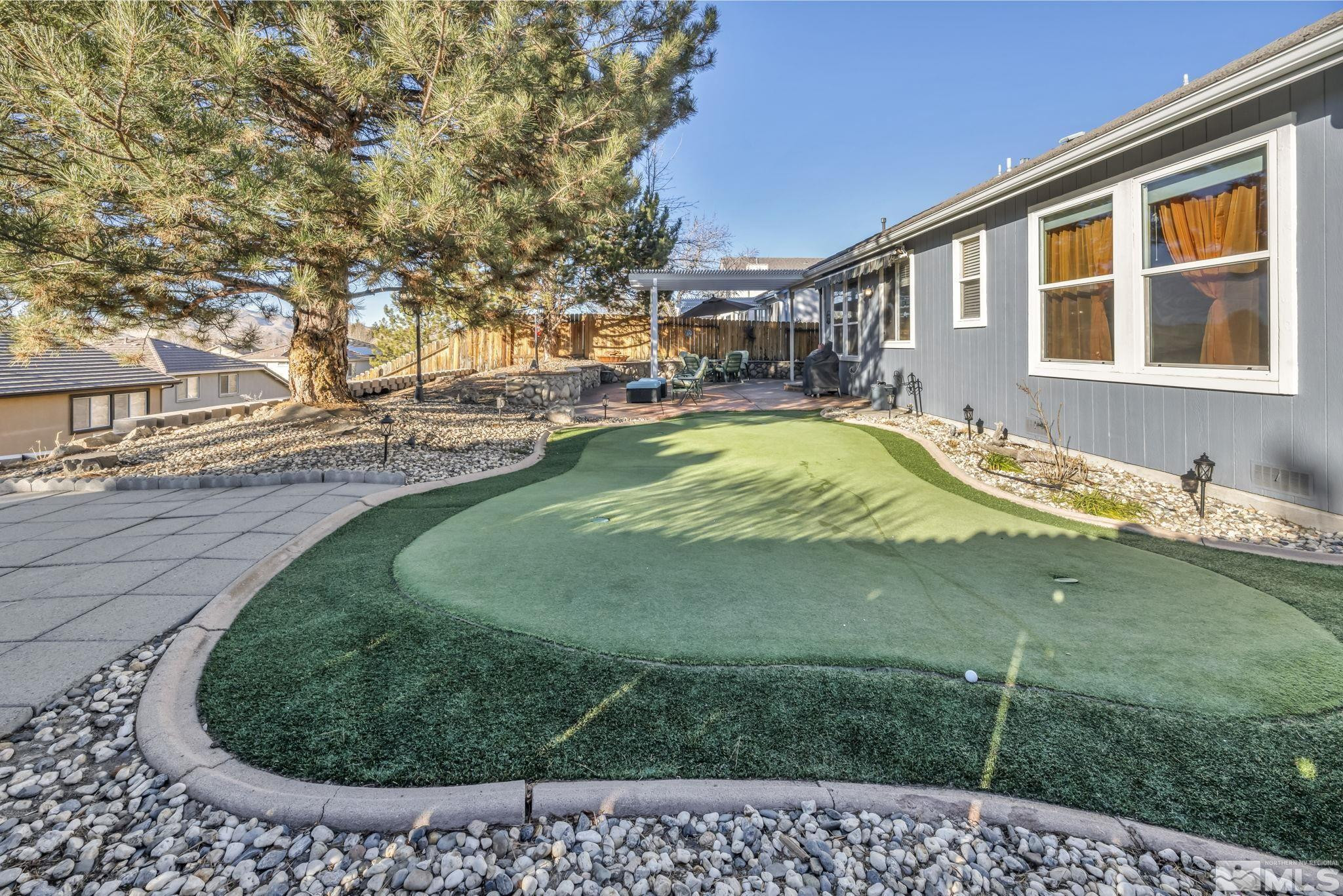 4805 Crestside Drive Sparks, NV 89436 - Photo 30 of 33 a swimming pool with outdoor seating and yard