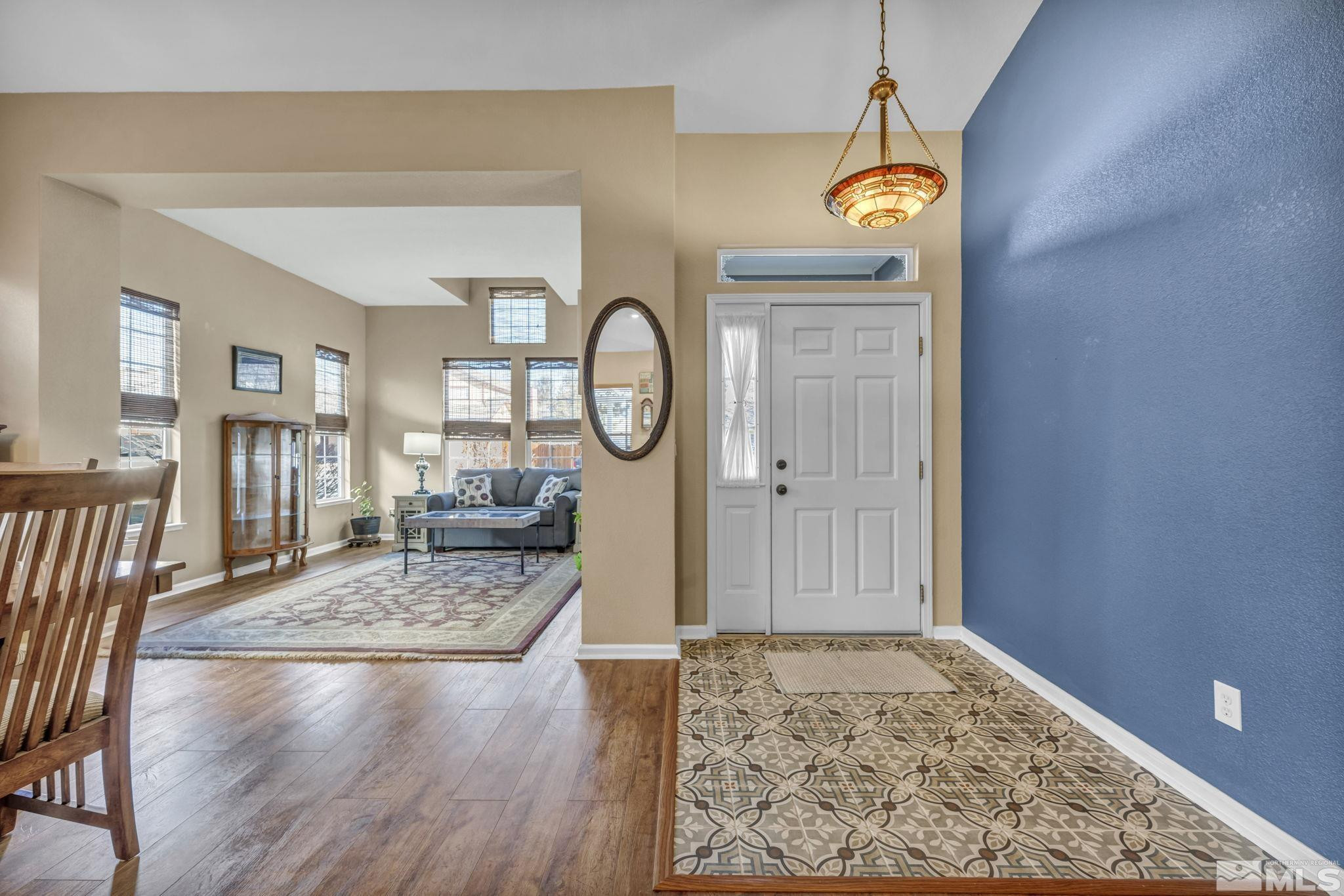 4805 Crestside Drive Sparks, NV 89436 - Photo 4 of 33 a view of a hallway to a livingroom and dining room with wooden floor