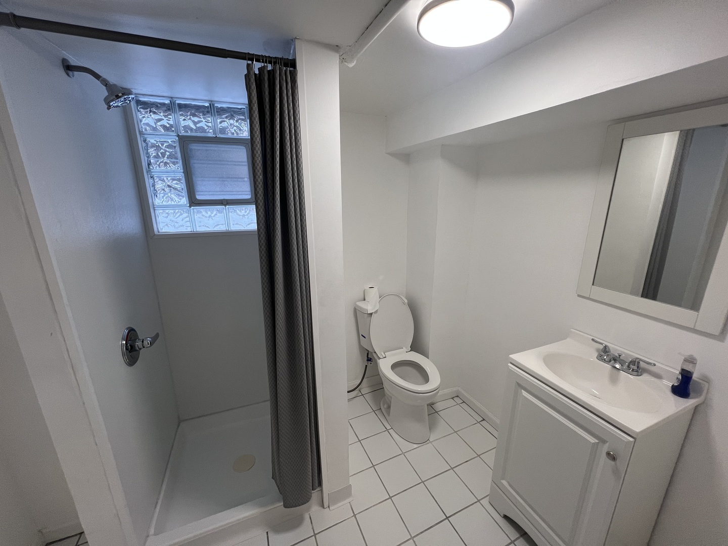 11945 South State Street Chicago, IL 60628 - Photo 14 of 16 a bathroom with a sink toilet and shower