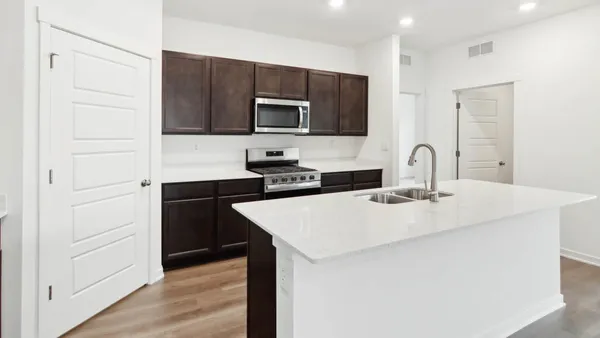 a kitchen with stainless steel appliances a sink and microwave