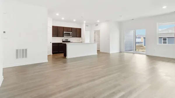 a view of kitchen with stainless steel appliances kitchen island wooden floor and window