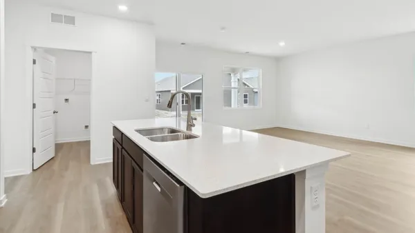 a kitchen with a sink a stove and a refrigerator