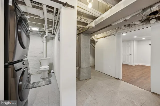 a view of a hallway with toilet and a washer