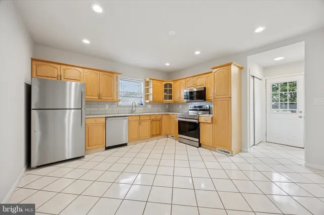 a kitchen with stainless steel appliances granite countertop a refrigerator sink and cabinets
