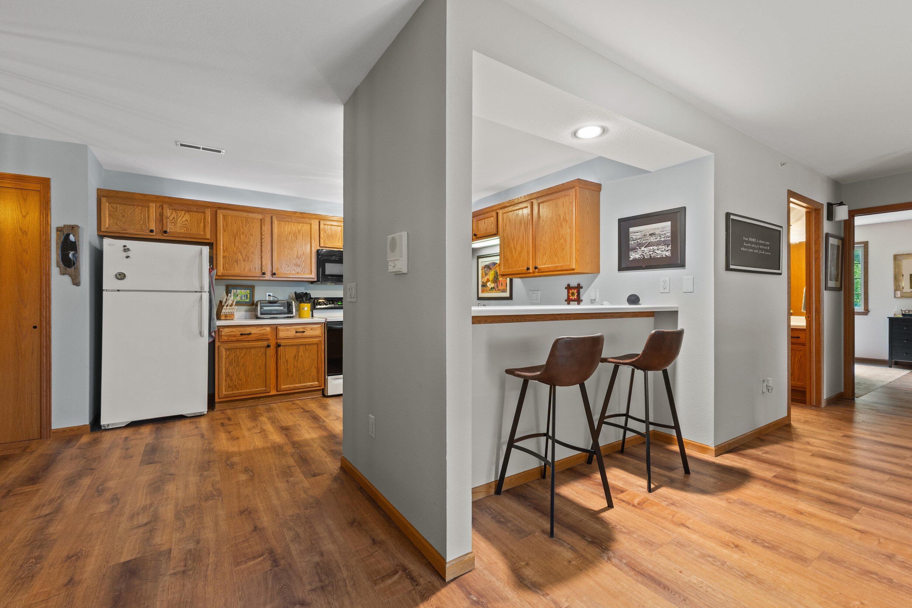 9342 West Loomis Road, Unit 8 Franklin, WI 53132 - Photo 2 of 29 kitchen with breakfast bar