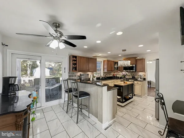 a kitchen with stainless steel appliances a sink stove and refrigerator