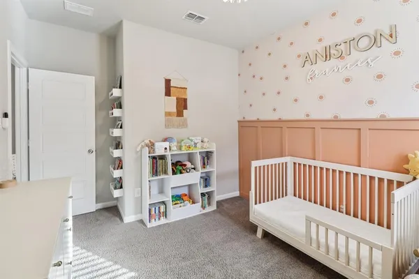 a bedroom with furniture and baby crib