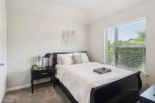 a bedroom with a bed and a table