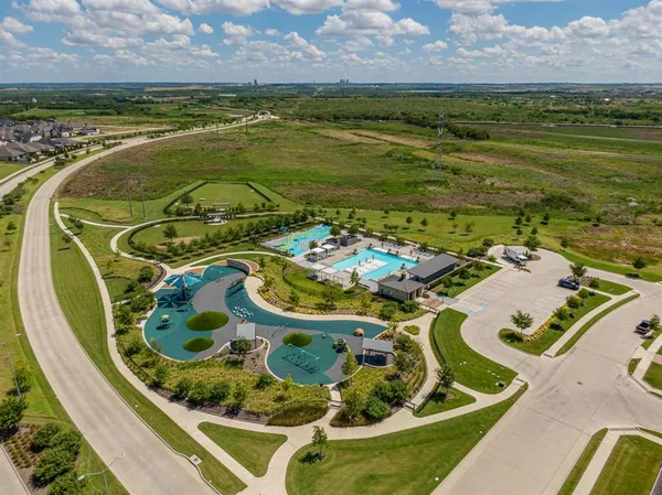 an aerial view of a swimming pool with a table and chairs