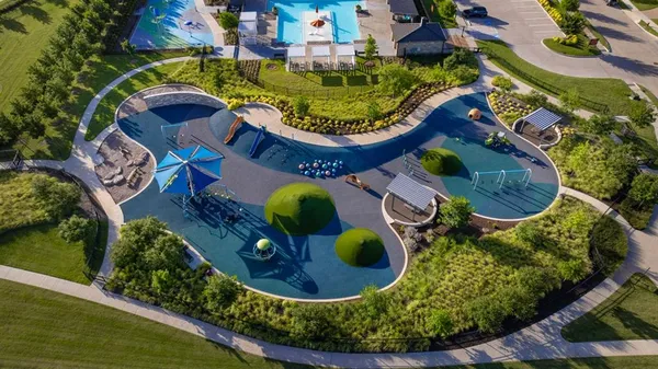 an aerial view of a house with swimming pool and outdoor seating