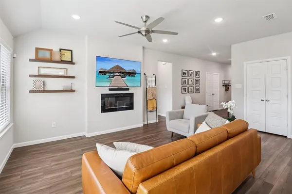a living room with furniture and a wooden floor