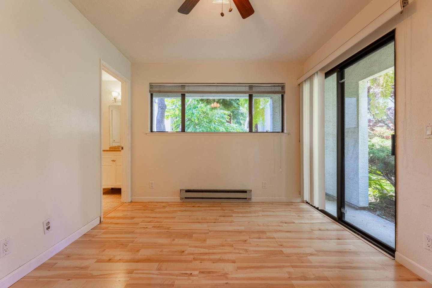 1055 North Capitol Avenue, Unit 51 San Jose, CA 95133 - Photo 15 of 23 a view of an empty room with wooden floor and a window