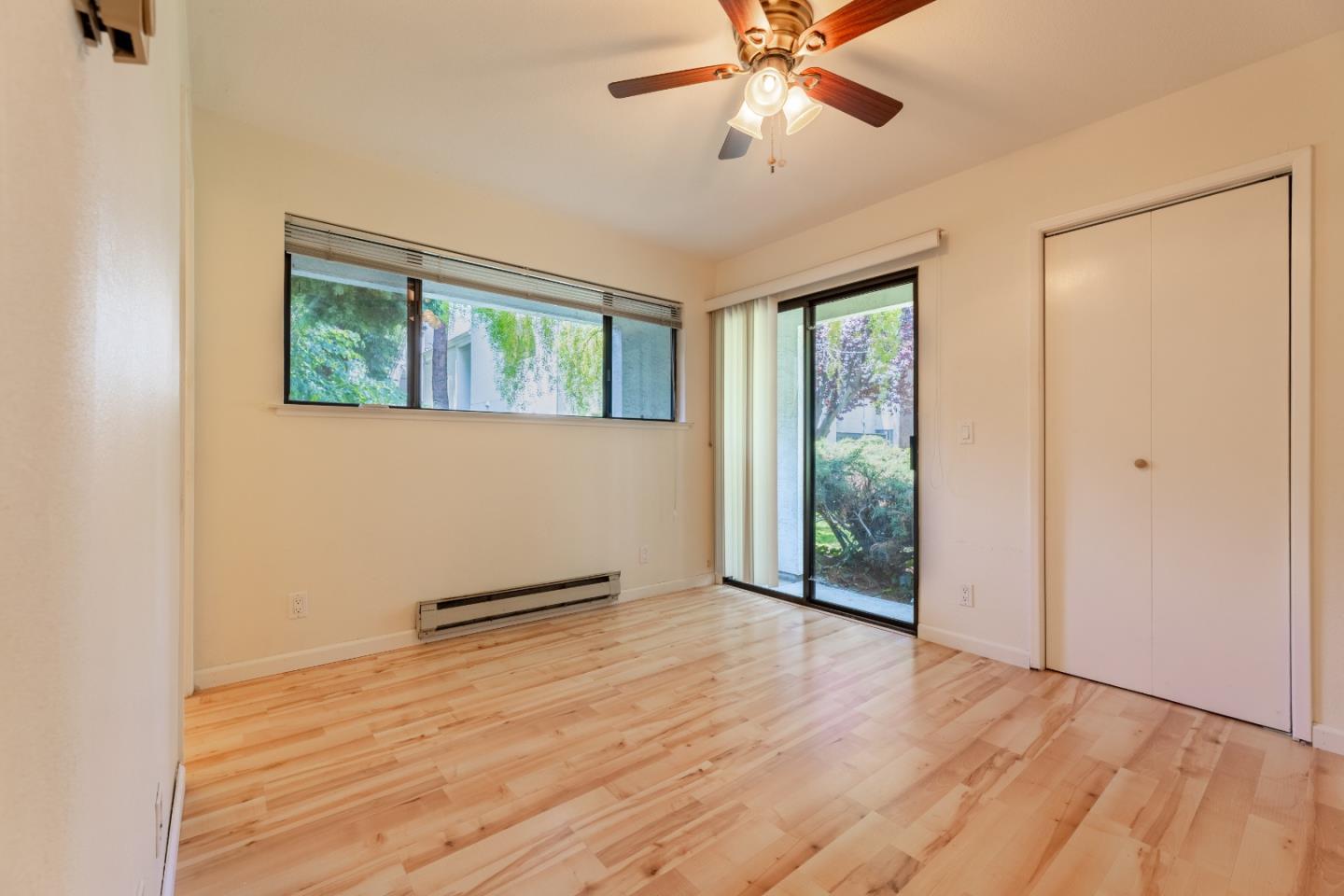 1055 North Capitol Avenue, Unit 51 San Jose, CA 95133 - Photo 23 of 23 an empty room with wooden floor fan and windows