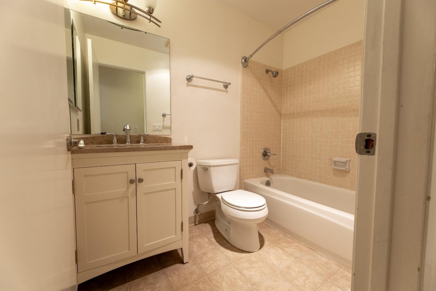 1055 North Capitol Avenue, Unit 51 San Jose, CA 95133 - Photo 10 of 23 a bathroom with a bathtub shower sink mirror vanity and a toilet