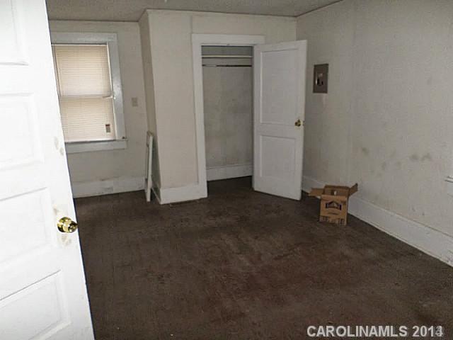 1705 Beatties Ford Road Charlotte, NC 28216 - Photo 4 of 6 an empty room with a bench