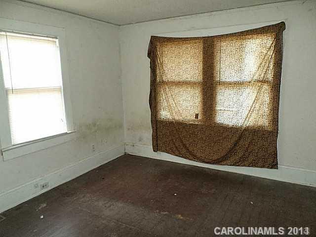 1705 Beatties Ford Road Charlotte, NC 28216 - Photo 5 of 6 an empty room with a window