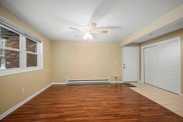 wooden floor in an empty room with a window