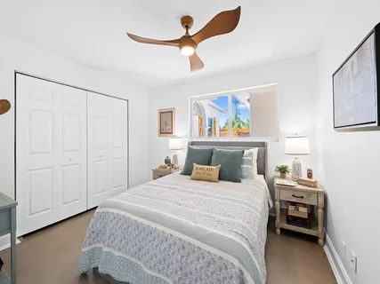 a bedroom with a bed and a painting on the wall