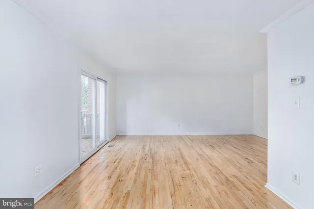 a view of an empty room and wooden floor