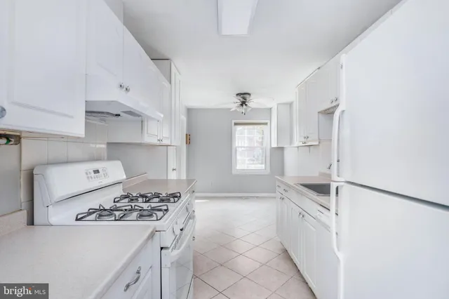 a kitchen with a sink stove and refrigerator