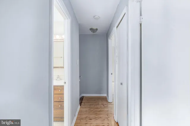 a view of hallway with closet and a window