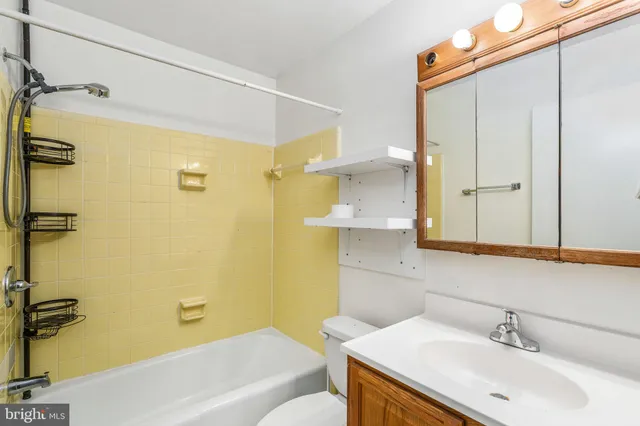 a bathroom with a sink mirror vanity and toilet