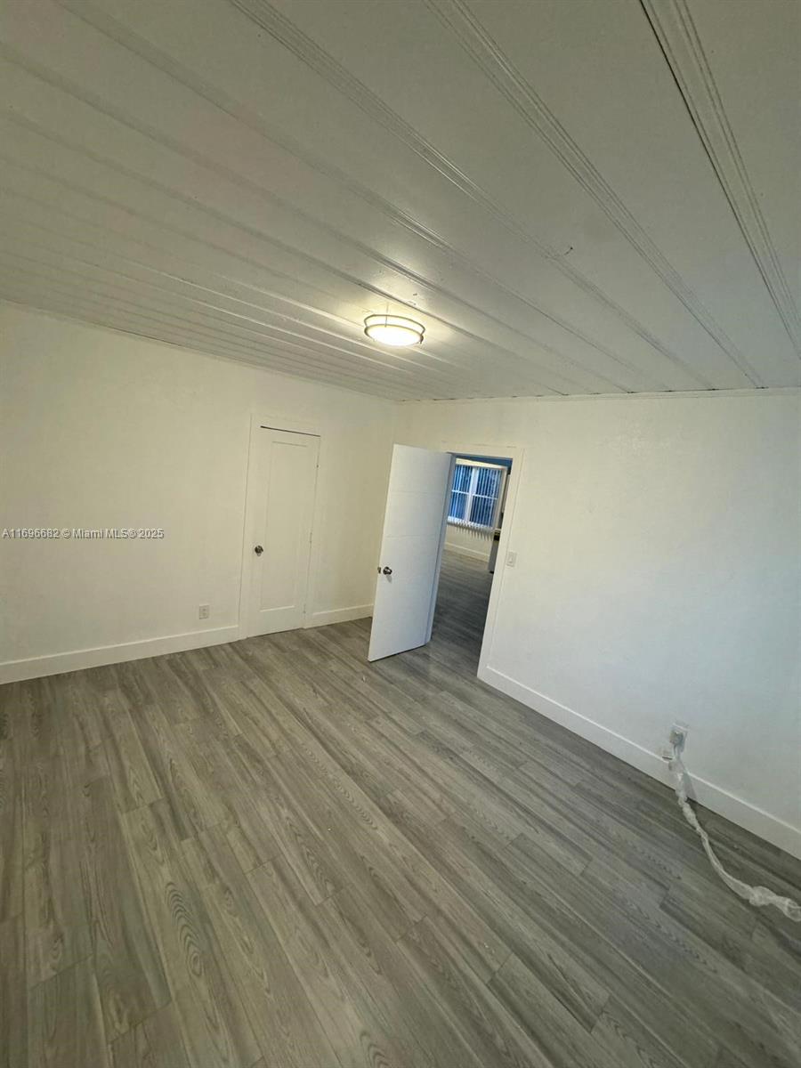501 Wendell Road, Unit A Fort Pierce, FL 34950 - Photo 11 of 17 an empty room with wooden floor and sink