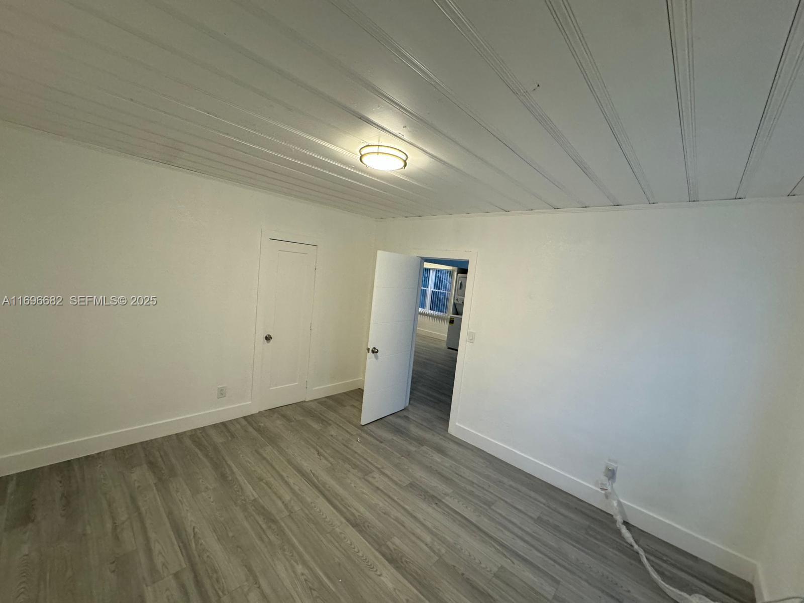 501 Wendell Road, Unit A Fort Pierce, FL 34950 - Photo 12 of 17 a view of an empty room with wooden floor