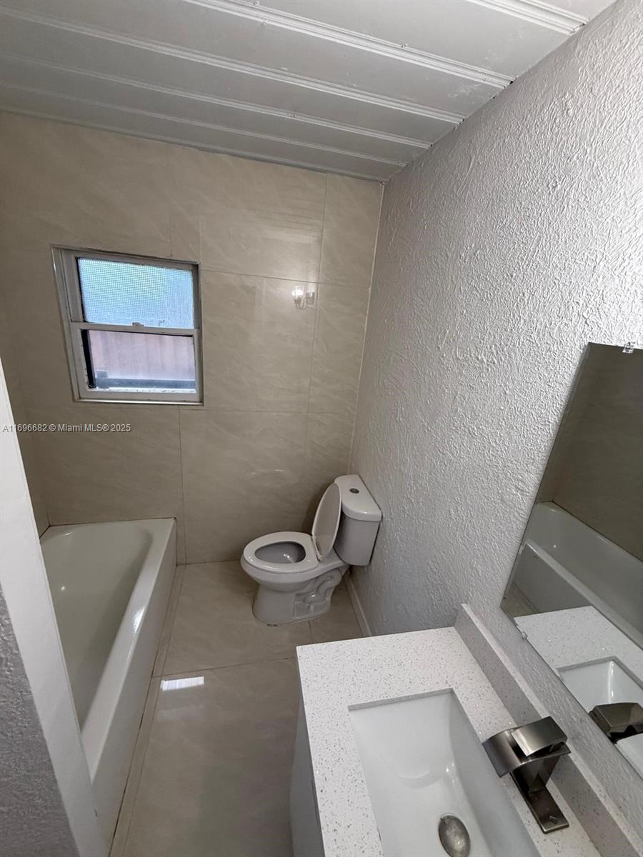 501 Wendell Road, Unit A Fort Pierce, FL 34950 - Photo 14 of 17 a bathroom with a sink and toilet