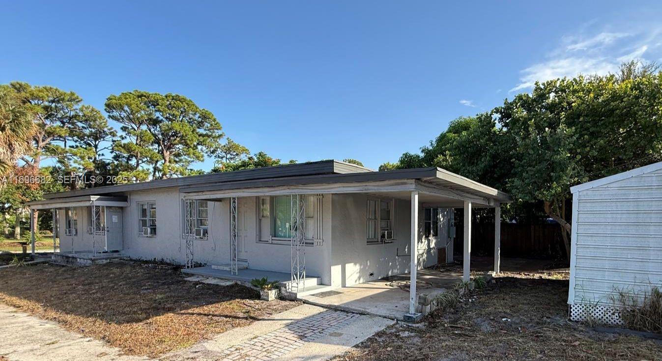 501 Wendell Road, Unit A Fort Pierce, FL 34950 - Photo 17 of 17 a front view of a house with garden
