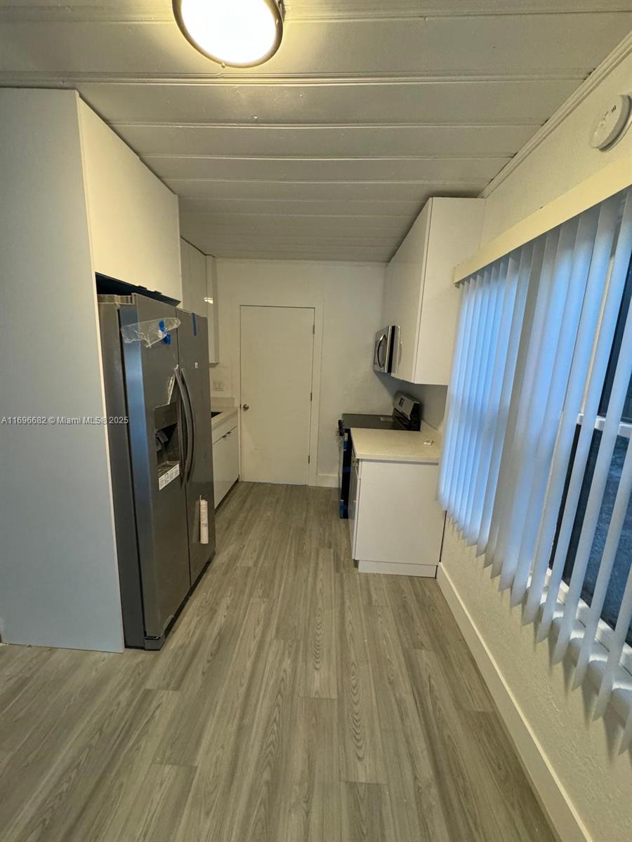 501 Wendell Road, Unit A Fort Pierce, FL 34950 - Photo 5 of 17 a utility room with wooden floor washer and dryer