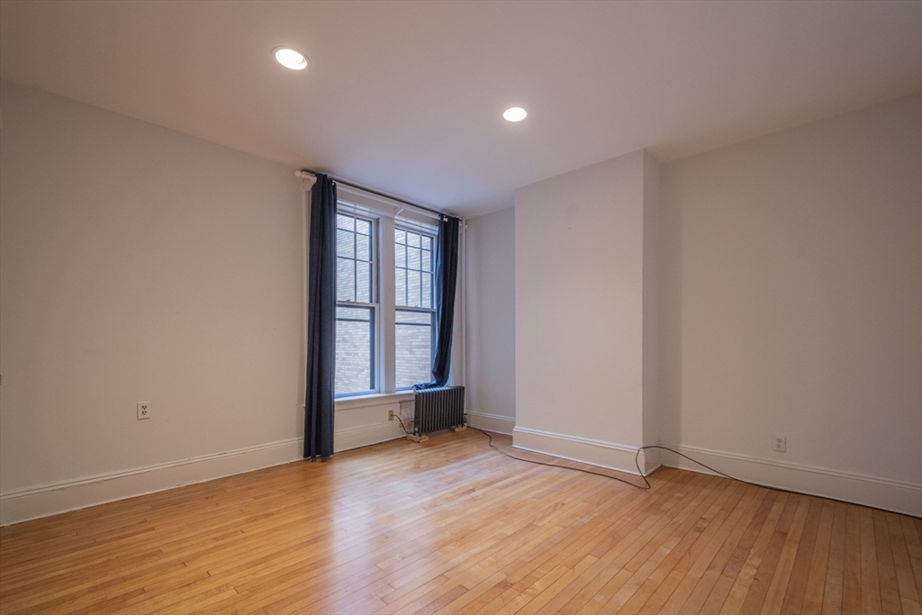 2 Newport Road, Unit 5 Cambridge, MA 02140 - Photo 13 of 18 an empty room with wooden floor and windows