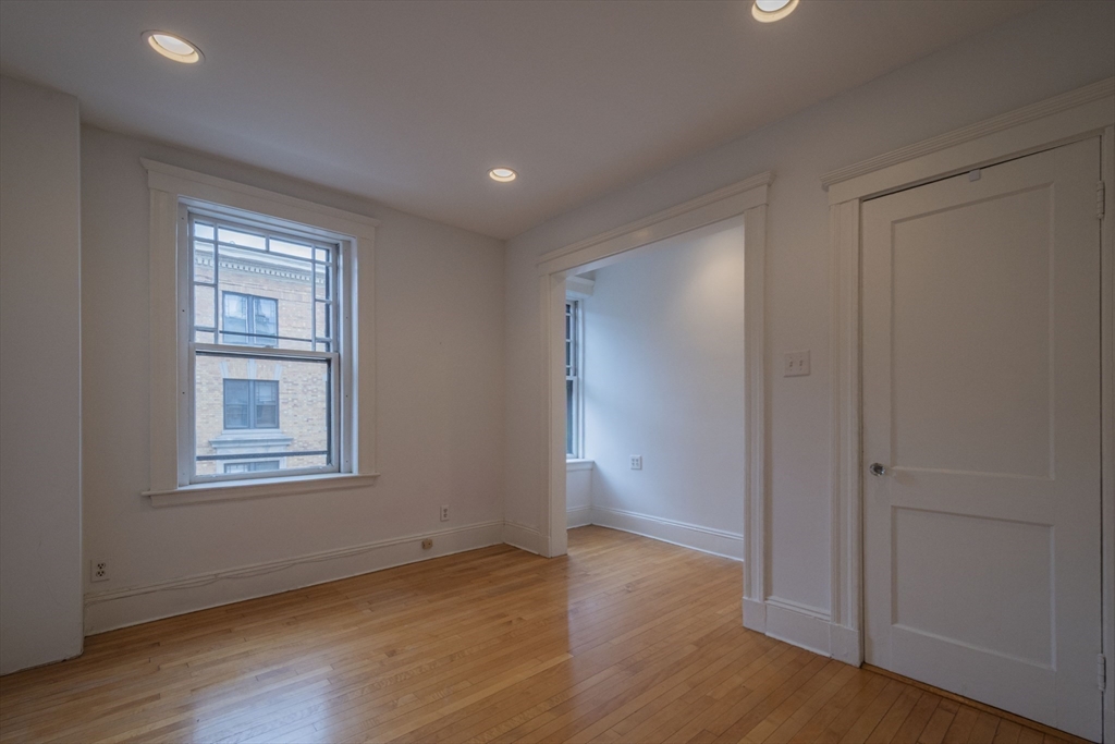 2 Newport Road, Unit 5 Cambridge, MA 02140 - Photo 16 of 18 an empty room with wooden floor and windows