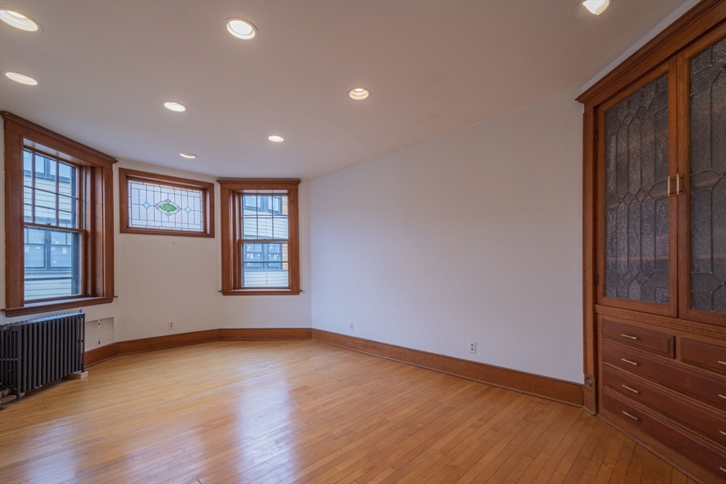 2 Newport Road, Unit 5 Cambridge, MA 02140 - Photo 8 of 18 a view of an empty room with a window and wooden floor