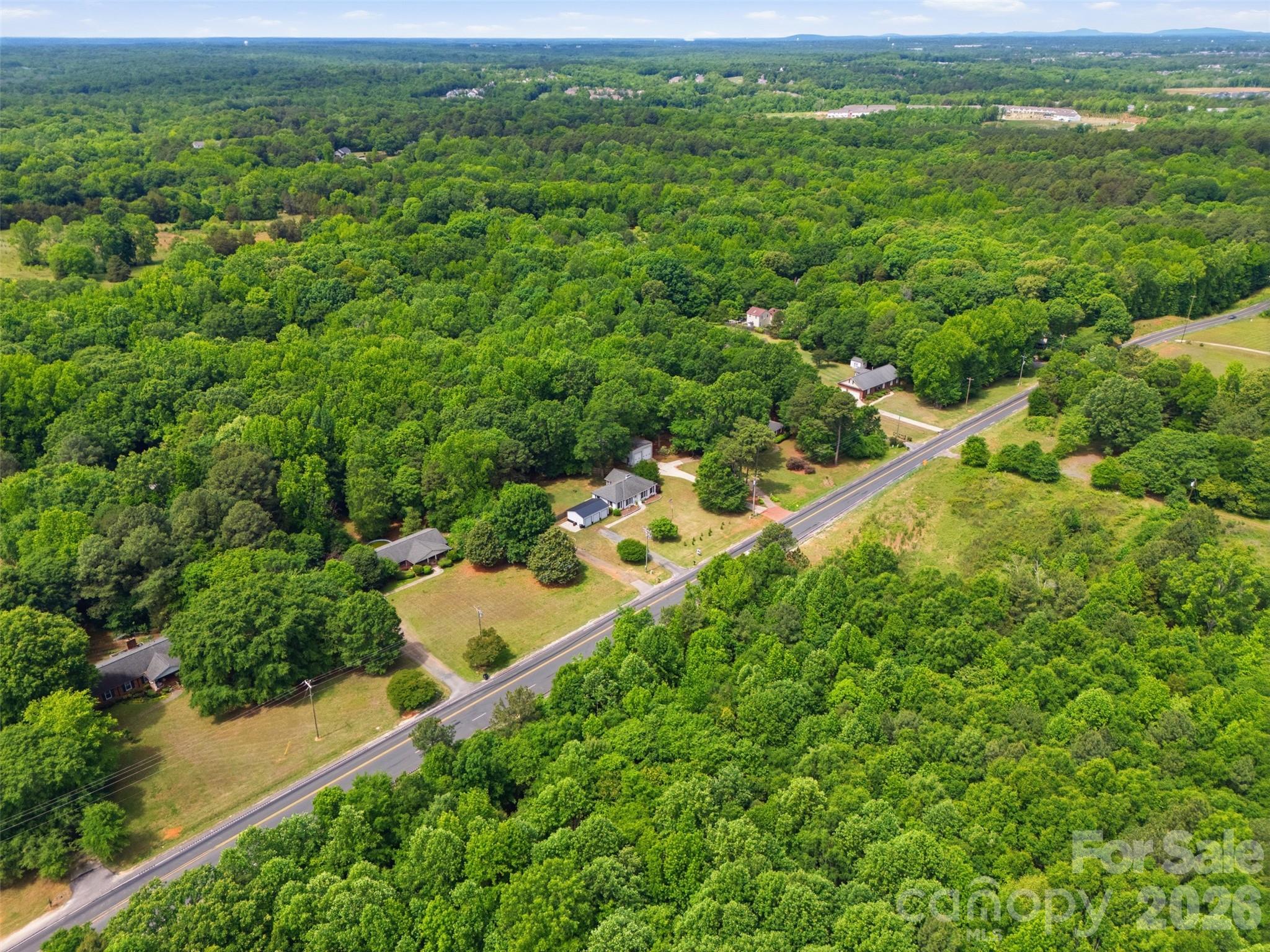 10919 Harrisburg Road Fort Mill, SC 29707 - Photo 42 of 43 an aerial view of residential houses with outdoor space and trees