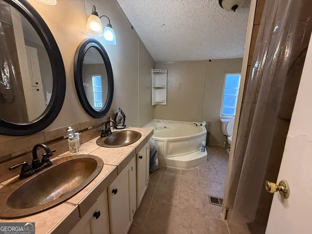 a bathroom with a double vanity sink and a mirror