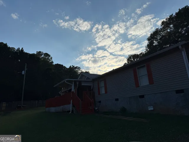 a view of house with backyard and garden