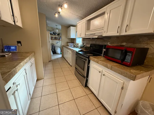 a kitchen with cabinets and appliances