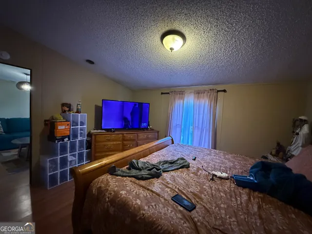 a bedroom with a bed and a lamp