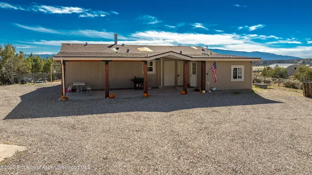 a view of a patio with table and chairs and potted plants