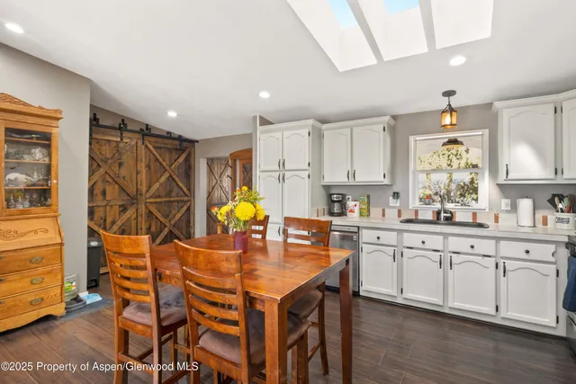 a kitchen with a sink cabinets and wooden floor