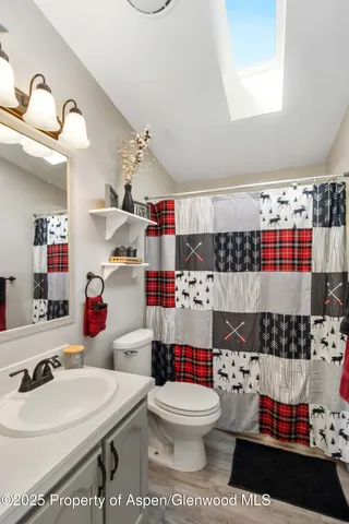 a bathroom with a sink toilet and shower