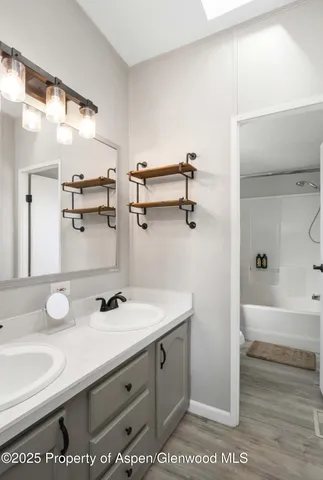 a bathroom with a sink and a mirror
