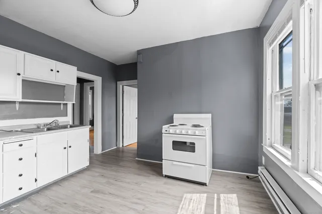 a kitchen with a stove a sink and a refrigerator