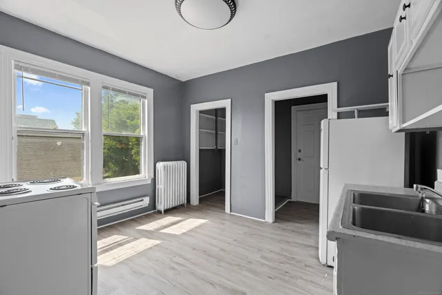 a kitchen with granite countertop a sink and a refrigerator
