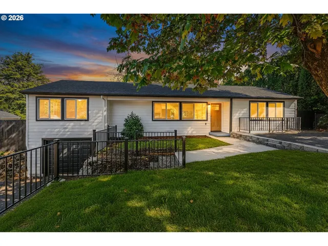 a view of a house with a swimming pool and a yard