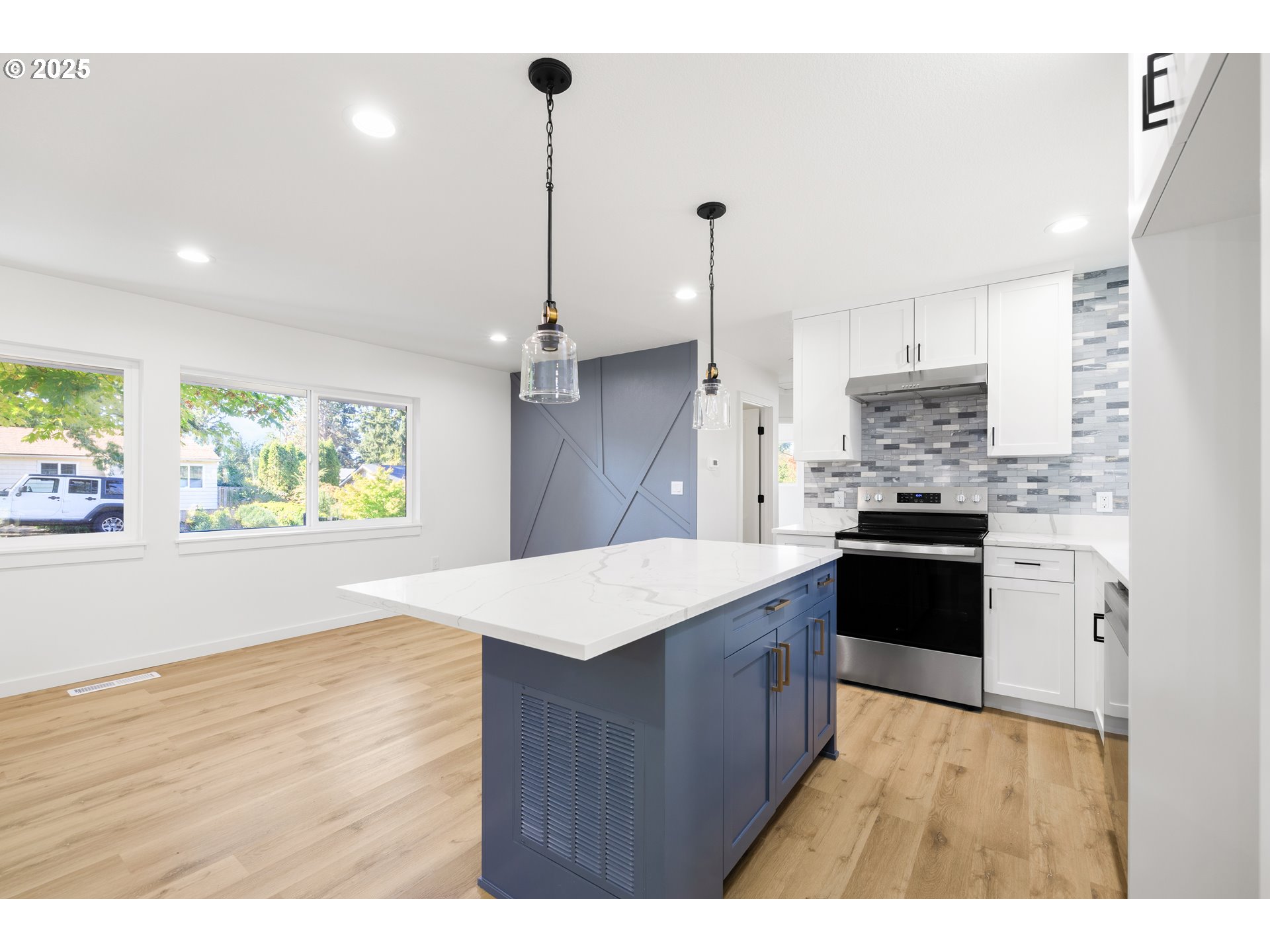 142 Northeast 128th Avenue Portland, OR 97230 - Photo 11 of 43 a kitchen with kitchen island a counter top space a sink stainless steel appliances and cabinets