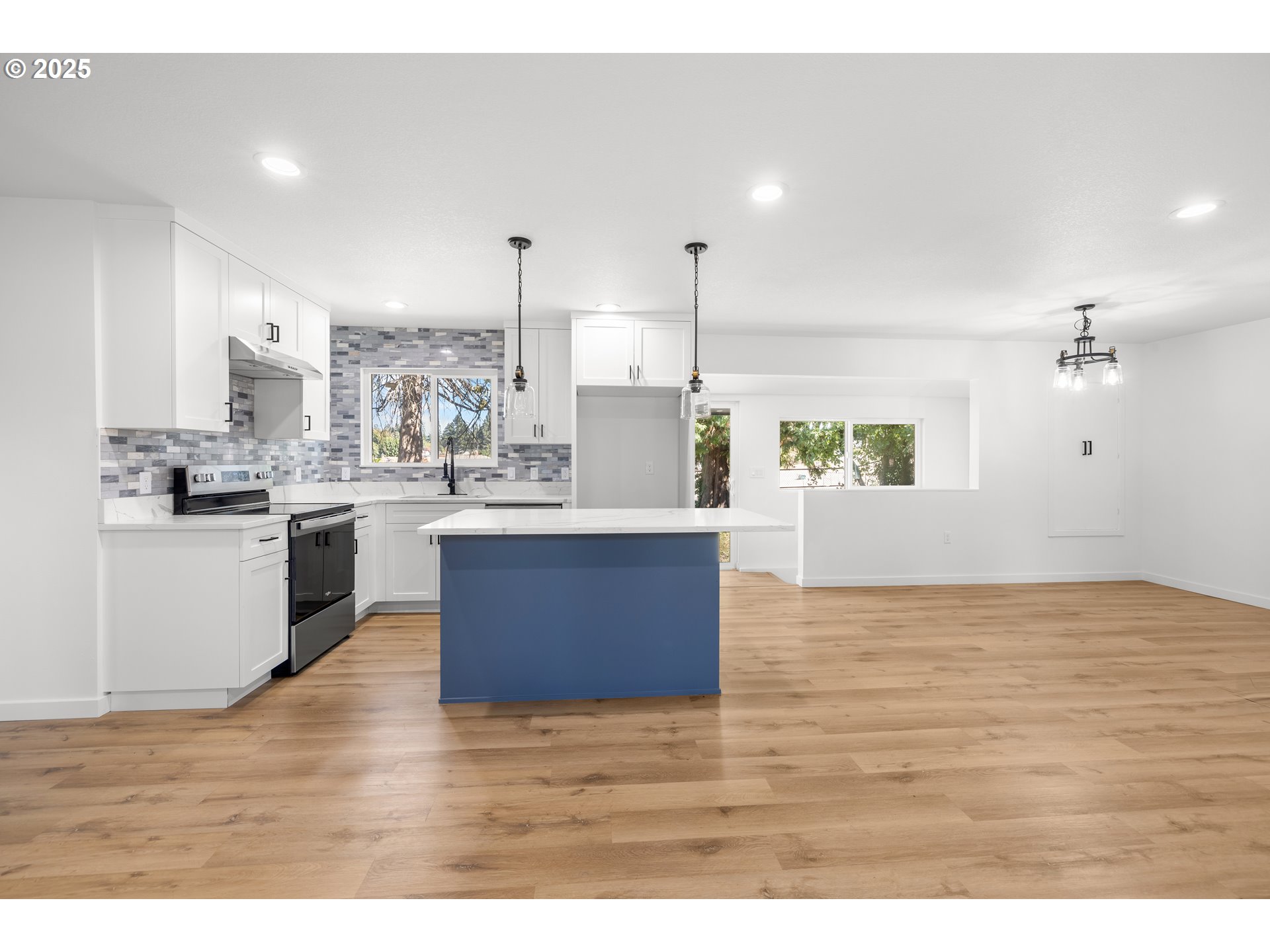 142 Northeast 128th Avenue Portland, OR 97230 - Photo 12 of 43 a open kitchen with kitchen island a sink dishwasher a stove with wooden cabinets